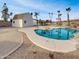 Backyard featuring pool, desert landscaping, palm trees, and bright blue sky against neutral colors at 5432 E Juniper Ave, Scottsdale, AZ 85254