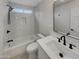 Modern bathroom featuring sleek marble tile, a soaking tub and shower with matte black hardware at 5432 E Juniper Ave, Scottsdale, AZ 85254