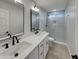 Elegant bathroom featuring dual sinks, modern fixtures, and a beautifully tiled walk-in shower at 5432 E Juniper Ave, Scottsdale, AZ 85254