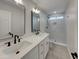 Luxurious bathroom with double vanity, sleek fixtures and a spacious glass enclosed shower with marble tile at 5432 E Juniper Ave, Scottsdale, AZ 85254