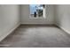 Bedroom with gray carpet and a window view of desert landscaping at 5432 E Juniper Ave, Scottsdale, AZ 85254