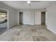 Spacious bedroom featuring tiled floors, neutral walls, two walk-in closets, and sliding door access to patio at 5432 E Juniper Ave, Scottsdale, AZ 85254