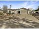 Stunning single-story home boasting manicured desert landscaping and a spacious driveway at 5432 E Juniper Ave, Scottsdale, AZ 85254