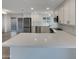 Close-up of the kitchen's quartz countertop and stainless steel appliances with white cabinets at 5432 E Juniper Ave, Scottsdale, AZ 85254