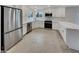 Modern white kitchen featuring stainless steel appliances, ample counter space, and a sleek design at 5432 E Juniper Ave, Scottsdale, AZ 85254