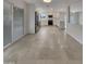 Modern kitchen with stainless steel appliances, white cabinetry, and tile flooring, adjacent to a living area at 5432 E Juniper Ave, Scottsdale, AZ 85254