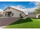 This home's backyard features artificial grass, a shed for storage, and an extended covered patio at 6060 W Charter Oak Rd, Glendale, AZ 85304