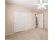 Neutral bedroom with a ceiling fan, closet with sliding doors, and doorway to the rest of the home at 6060 W Charter Oak Rd, Glendale, AZ 85304