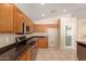 Modern kitchen featuring granite countertops and sleek stainless steel appliances at 6060 W Charter Oak Rd, Glendale, AZ 85304