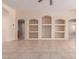 Open-concept living room with recessed shelving and tile flooring throughout at 6060 W Charter Oak Rd, Glendale, AZ 85304