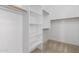 Spacious walk-in closet with built-in shelving, providing ample storage space for clothing at 6060 W Charter Oak Rd, Glendale, AZ 85304