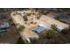 Aerial view showing the estate layout featuring homes, outbuildings, and equestrian facilities at 6611 E Peak View Rd, Cave Creek, AZ 85331