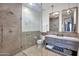 Bathroom with tile shower, gray cabinets, and marble countertops at 6611 E Peak View Rd, Cave Creek, AZ 85331