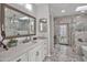 Luxurious bathroom with double vanities, a skylight, marble finishes, and a separate tiled shower at 6611 E Peak View Rd, Cave Creek, AZ 85331