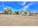 Metal building with garage doors and desert landscaping under a bright blue, partly cloudy sky at 6611 E Peak View Rd, Cave Creek, AZ 85331