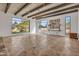 Spacious living room with large windows offering expansive views of the desert landscape and a unique parquet floor design at 6611 E Peak View Rd, Cave Creek, AZ 85331