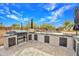 Outdoor kitchen with built-in grill, bar area, and tile accents, designed for alfresco dining and entertaining at 6611 E Peak View Rd, Cave Creek, AZ 85331