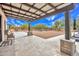 Covered patio offers a relaxing view of the spacious backyard, complete with mature trees and serene landscaping at 6611 E Peak View Rd, Cave Creek, AZ 85331