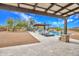 Expansive pool area featuring a covered patio, built-in spa, and lounge seating against a backdrop of desert landscape at 6611 E Peak View Rd, Cave Creek, AZ 85331