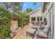 Landscaped backyard featuring a patio with lounge chairs, fountain, and lush green foliage and flowers at 6801 N 1St Pl, Phoenix, AZ 85012