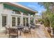 Backyard patio with outdoor seating and view of house with awning over arched windows and doors at 6801 N 1St Pl, Phoenix, AZ 85012