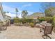 Outdoor backyard featuring a patio with lounge seating, a grill, and lush greenery with palm trees at 6801 N 1St Pl, Phoenix, AZ 85012