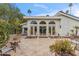 Backyard patio featuring tiled floor, outdoor seating, white exterior house with arched windows and palm trees at 6801 N 1St Pl, Phoenix, AZ 85012