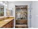 Modern bathroom featuring a glass shower with nature view, granite countertops, and vanity with dual mirrors at 6801 N 1St Pl, Phoenix, AZ 85012