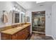 Luxurious bathroom featuring double vanity with granite countertop and a glass-enclosed shower at 6801 N 1St Pl, Phoenix, AZ 85012