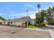 Charming single-story home featuring a two-car garage, manicured landscaping, and a neutral stucco facade at 6801 N 1St Pl, Phoenix, AZ 85012