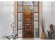 Inviting entryway featuring a decorative wood door with glass panels and a stylish glass table at 6801 N 1St Pl, Phoenix, AZ 85012