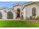 Elegant home featuring a decorative front door with glass sidelights and a manicured lawn at 6801 N 1St Pl, Phoenix, AZ 85012