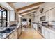 Bright kitchen featuring stone countertops, stainless steel appliances, white cabinets, and an eat-in dining nook at 6801 N 1St Pl, Phoenix, AZ 85012