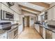 Spacious kitchen featuring stone countertops, stainless steel appliances, white cabinets, and tile floors at 6801 N 1St Pl, Phoenix, AZ 85012