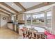 Bright eat-in kitchen nook area featuring a bay window with cushioned bench seating, and beamed ceilings at 6801 N 1St Pl, Phoenix, AZ 85012