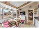 Bright eat-in kitchen nook area featuring a bay window with cushioned bench seating and a mounted TV at 6801 N 1St Pl, Phoenix, AZ 85012