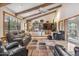 Comfortable living room featuring exposed beams, built-in shelves, and a plush leather sofa at 6801 N 1St Pl, Phoenix, AZ 85012