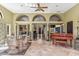 Sun-drenched living area featuring wicker furniture, travertine floors, and a tranquil ambiance at 6801 N 1St Pl, Phoenix, AZ 85012