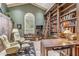 Inviting living room features vaulted ceiling, large windows, and built-in bookshelves with rolling ladder at 6801 N 1St Pl, Phoenix, AZ 85012