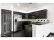 Modern kitchen with black cabinets and stainless steel appliances at 7601 E Roosevelt St # 1007, Scottsdale, AZ 85257