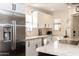 Well-lit kitchen with stainless steel appliances, sleek white cabinetry, and granite countertops at 7755 E Thomas Rd # 8, Scottsdale, AZ 85251