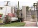 Cozy patio featuring artificial grass, potted plants, and an inviting outdoor chair at 7755 E Thomas Rd # 8, Scottsdale, AZ 85251