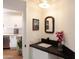 Charming powder room featuring a stylish vanity with a black countertop and decorative mirror at 7755 E Thomas Rd # 8, Scottsdale, AZ 85251