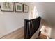 Modern staircase with dark railings and light hardwood floors, leading to upper level at 7755 E Thomas Rd # 8, Scottsdale, AZ 85251