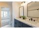 Bathroom featuring double sinks, modern fixtures, and a view into the bedroom at 7801 N 44Th Dr # 1059, Glendale, AZ 85301