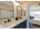 Bathroom featuring double sinks, modern fixtures, and a view into the bedroom at 7801 N 44Th Dr # 1059, Glendale, AZ 85301