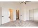 Bright bedroom with a ceiling fan and adjoining bathroom and mirrored closet doors at 7801 N 44Th Dr # 1059, Glendale, AZ 85301