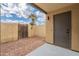 Enclosed patio with block wall, gravel landscaping, and wooden gate offers privacy at 7801 N 44Th Dr # 1059, Glendale, AZ 85301