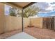 Enclosed patio with brick fire pit, gravel landscaping, and wooden gate at 7801 N 44Th Dr # 1059, Glendale, AZ 85301