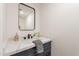 Contemporary powder room showcasing stylish mirror, quartz countertop, and black hardware at 7801 N 44Th Dr # 1059, Glendale, AZ 85301